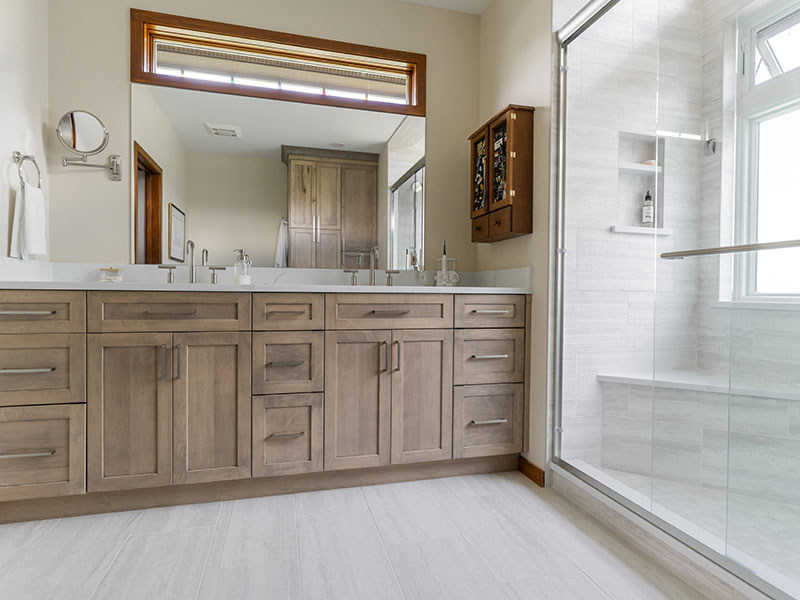 Bathroom Remodel Featuring Custom Vanity with Quartz Top, Low Curb Shower with Built-In Porcelain Bench and Niche