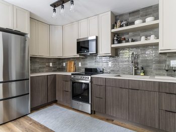 Kitchen design with two color cabinets, open shelves, stacked tile backsplash
