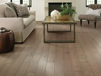 Hardwood flooring in living room with sofa and sofa table